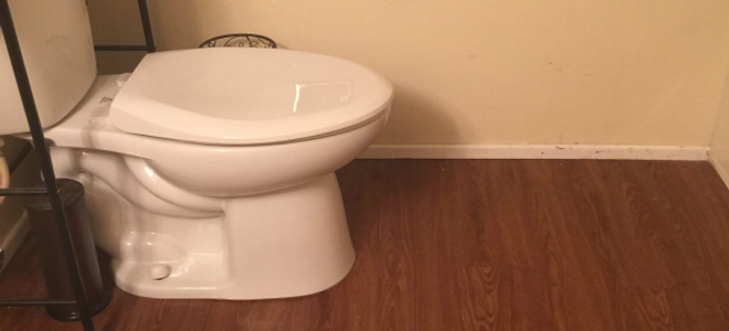 How do you cut laminate flooring around a toilet?