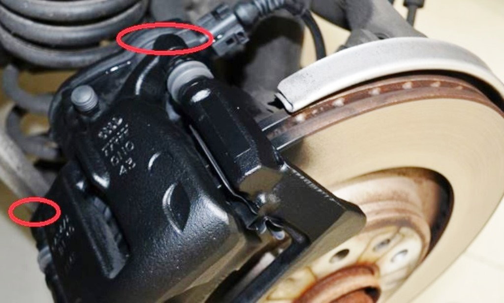 The location of the caliper slider bolts