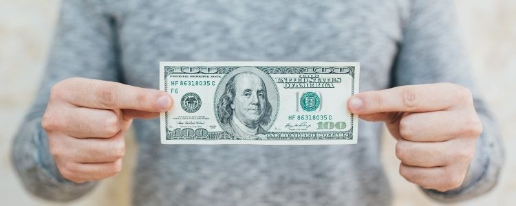 man holding $100 bill