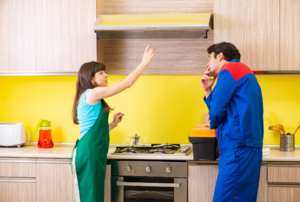 man and woman pointing and discussing a range hood