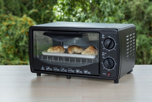 black toaster oven with crossiants inside