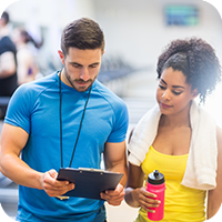 image of woman working with a personal trainer. 