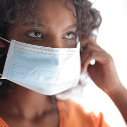 Woman putting on a surgical mask