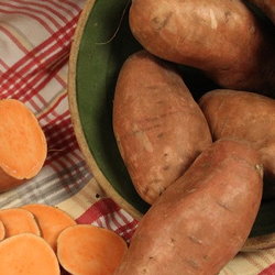 Fresh sweet potatoes in an antique bowl