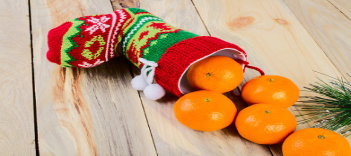 Christmas stocking with oranges rolling out.