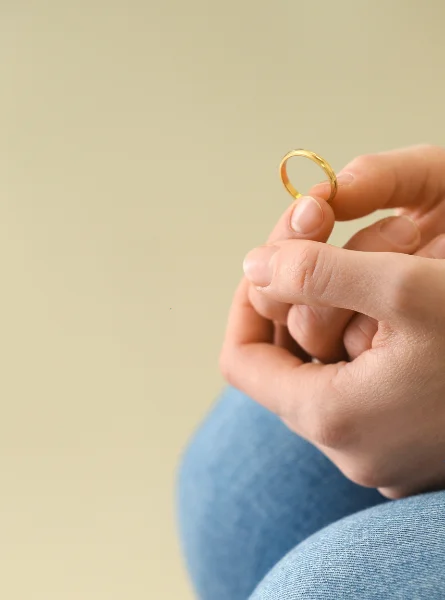 Photograph of a person holding a wedding ring