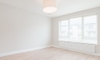 a white empty room with wood floors