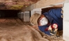 person with a mask in a crawlspace