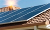 A set of solar panels on a red tile roof with a sun shining over it.