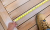 taking a measurement on a deck