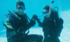 man proposing to woman underwater in scuba gear