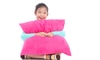 A young girl holding a pink body pillow.