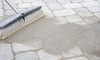 brush moving paver sand into walkway