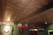 Faux brass ceiling tiles in an English-style basement.
