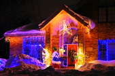 A brick house at night with Christmas lights.