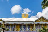 A tin roof on a yellow home.