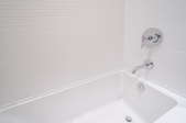 Bathtub with white walls