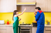 man and woman pointing and discussing a range hood