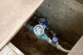 open crawl space with water pipes