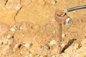 A ground wire attached to a grounding rod sunk into the dirt.