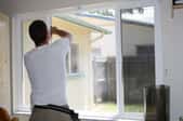 Man installing window film