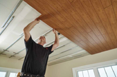 man installing ceiling planks