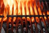 flames rising from a charcoal grill