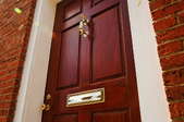 burgundy front door with brass hardware