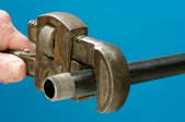 tightening pipe with pipe wrench