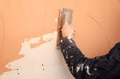 putting being spread over a plaster wall