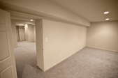 A renovated basement space with white walls.
