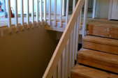 Several unfinished wooden stair treads of a two-story home.