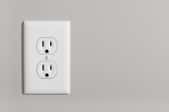 An outlet against a gray wall.