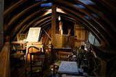 A darkly-lit attic full of antique junk.