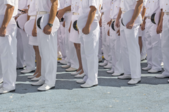 Rows of soldiers dressed in white Navy uniforms