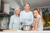 Three generations of women in a kitchen.