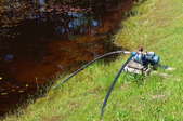 water pump with hose in a pond