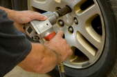 Using an impact wrench to remove lug nuts