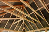 Several exposed rafters in a construction project.