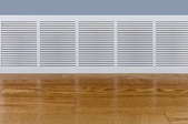 baseboard heater in a room with wood floor