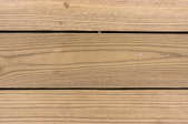 Several planks of pressure treated wood decking.