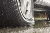 a flat tire on wet concrete