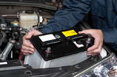 mechanic replacing a car battery