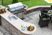 A flagstone patio with BBQ