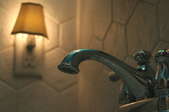 A nightlight in a bathroom with a faucet in the foreground. 