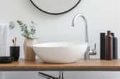 modern curved bowl sink with faucet in clean bathroom