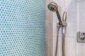 shower stall with tile and stone walls