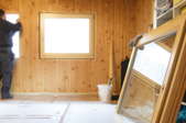 room under construction with wood paneling and glass windows