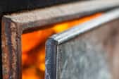 metal wood stove with door open to fire inside