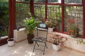 sunroom with plants and chairs